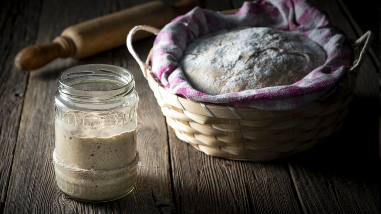 sourdough starter in jar beside bread