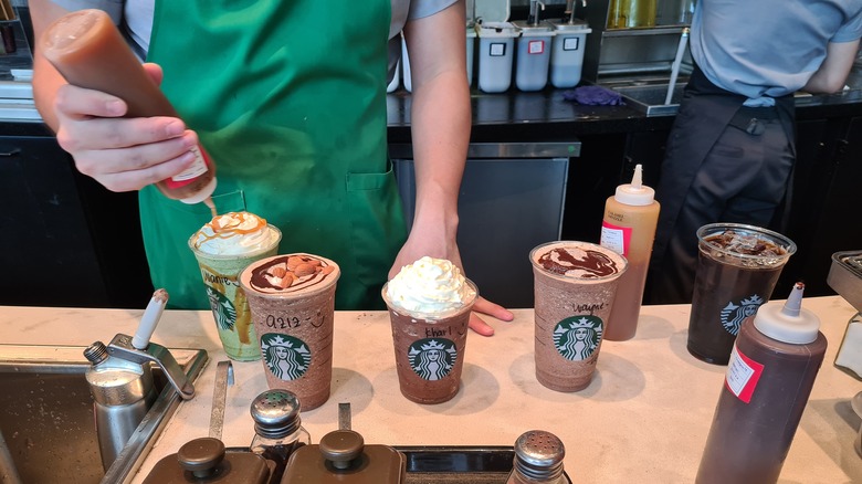 starbucks barista preparing various drinks