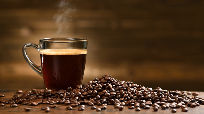 Coffee beans and mug of coffee