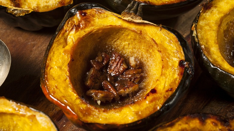 Close-up of a roasted acorn squash half with pecans