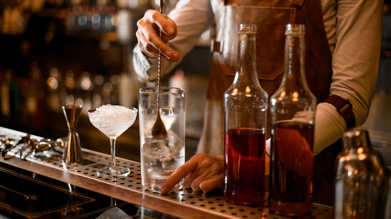 A bartender stirring a cocktail