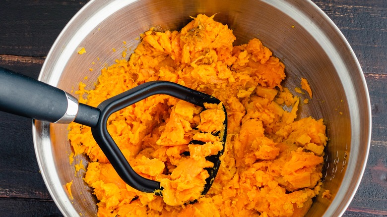 mashed sweet potatoes with masher