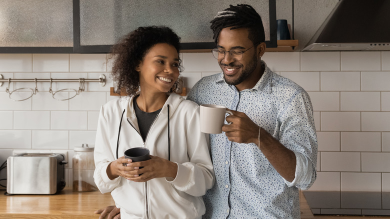 Couple drinking coffee in kitchen