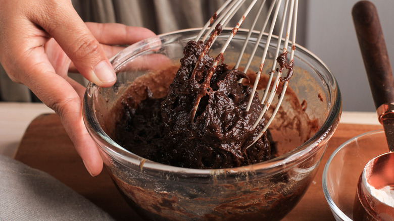 Cook whisking brownie batter