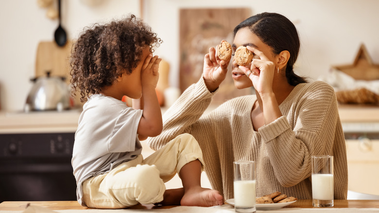 Mother and child holding cookies 