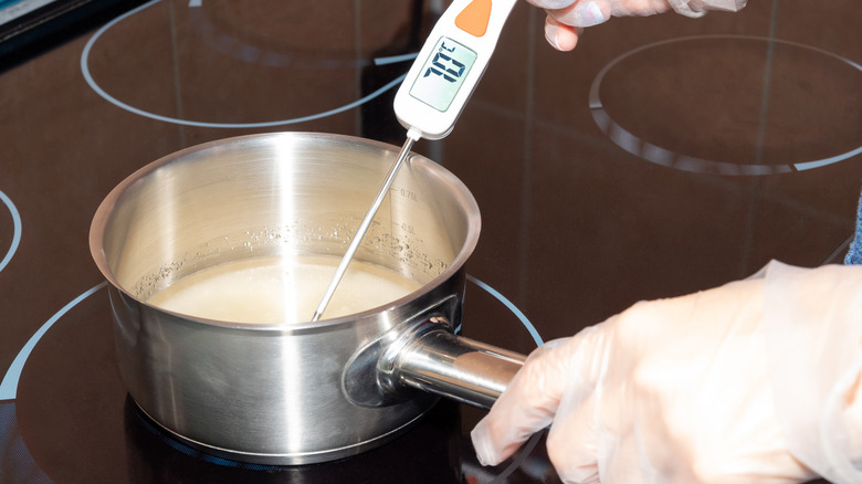 hands using candy thermometer