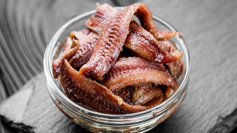 salted anchovies in glass bowl