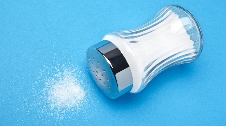 salt shaker on blue surface 