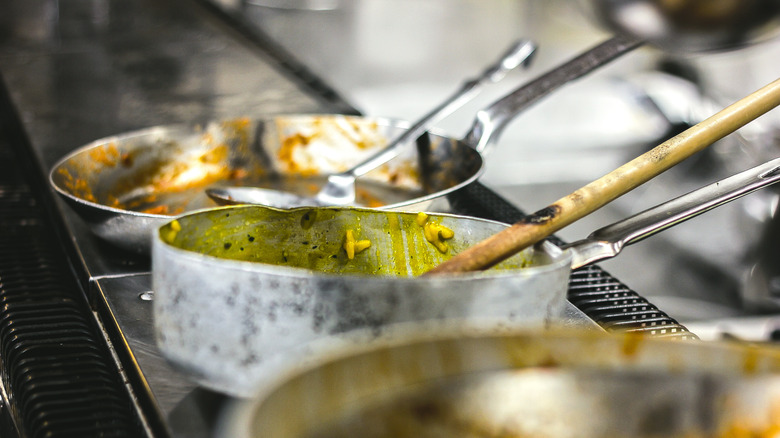 Saucier pans in restaurant kitchen