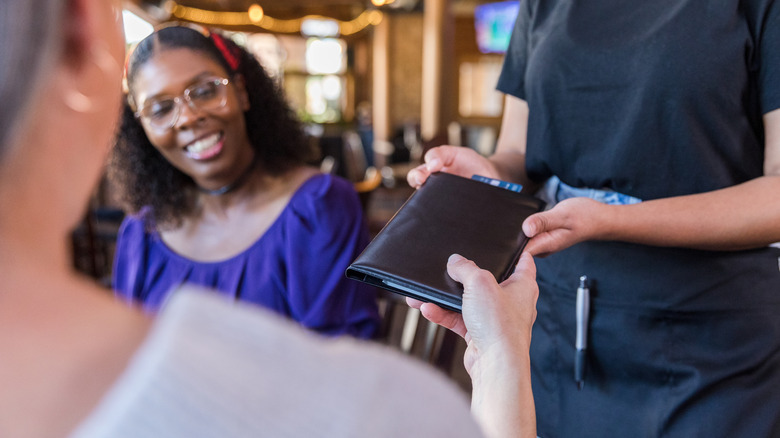 diners paying bill at restaurant