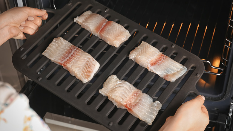 Fish filets going under the broiler 