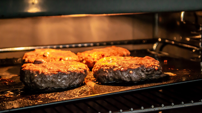 Burgers cooking under the broiler