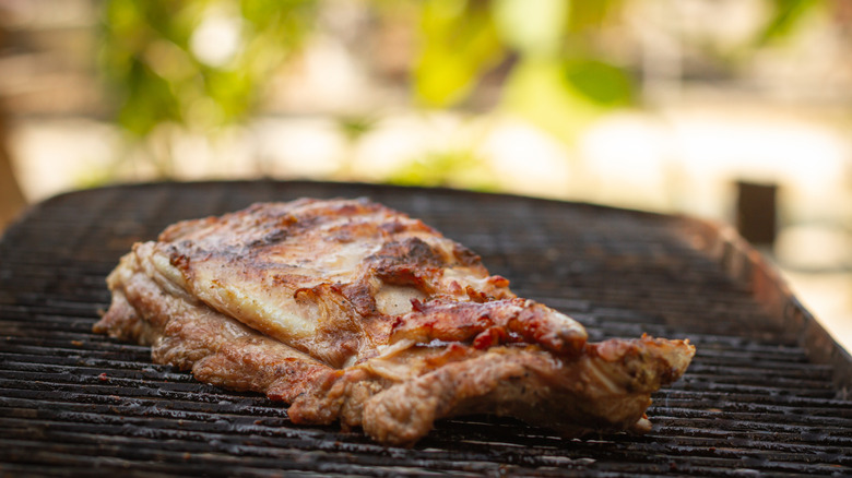 Prime rib cooking on a grill