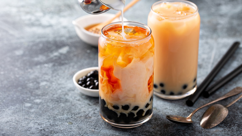 Milk pouring into boba tea