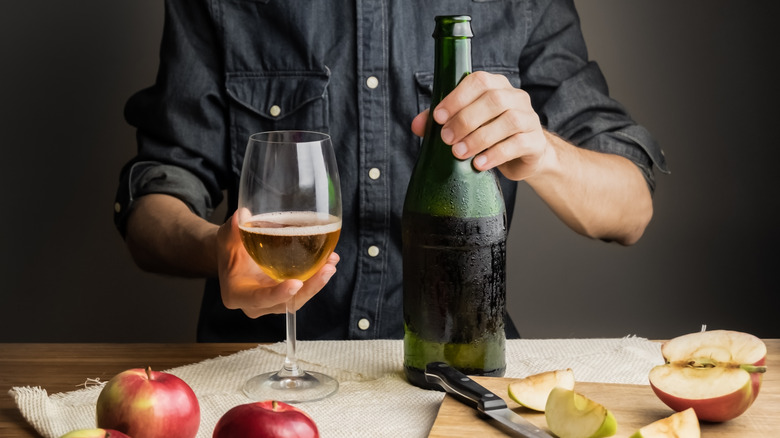 Person with bottle of cider