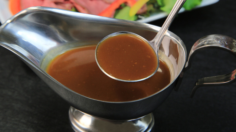 au jus in a serving dish with a ladel
