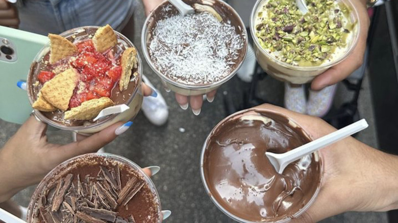 hands holding flavored tiramisu