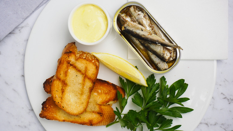 sardines, toast, and butter on plate