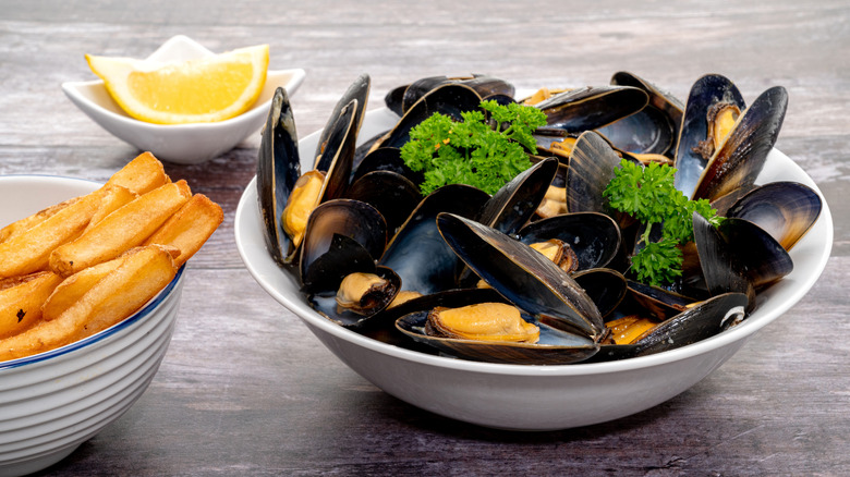 mussels and french fries in bowls