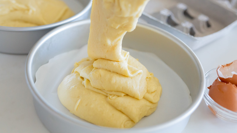 Filling a white cake pan