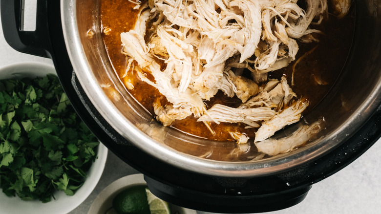 crock pot filled with shredded chicken