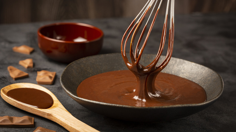 hand whisking chocolate ganache in a bowl