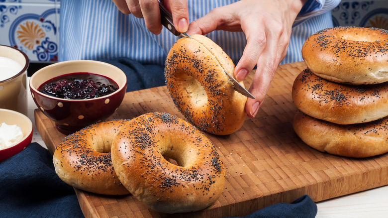 Person cutting bagel in half