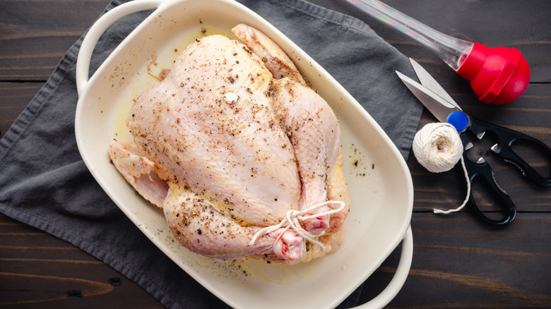 Seasoned raw chicken in baking dish