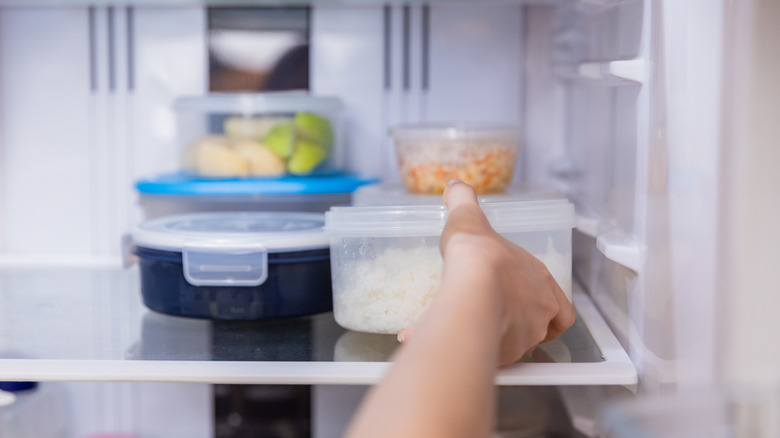 Person getting leftovers out of the fridge