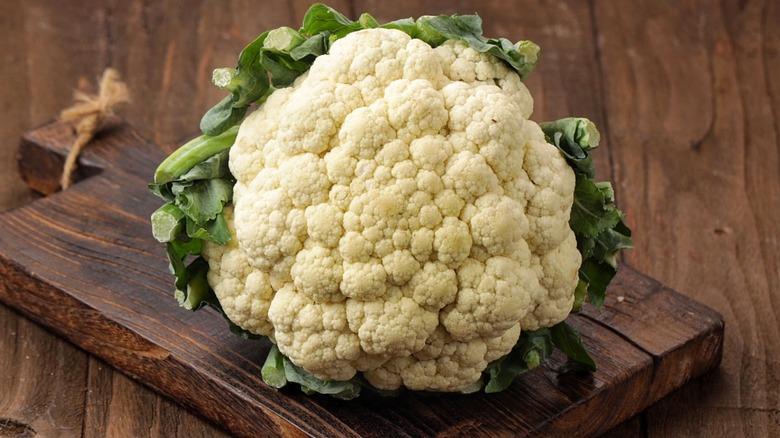 Raw cauliflower on cutting board