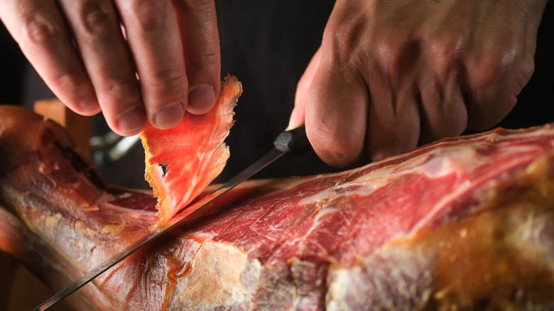 serrano ham being cut
