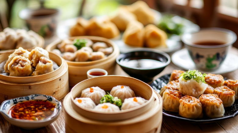 a variety of dumplings and dipping sauces