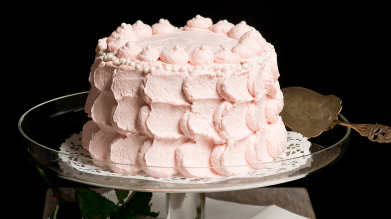 cake with scalloped pink frosting