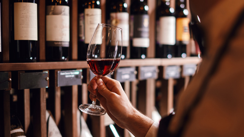 Person swirling red wine