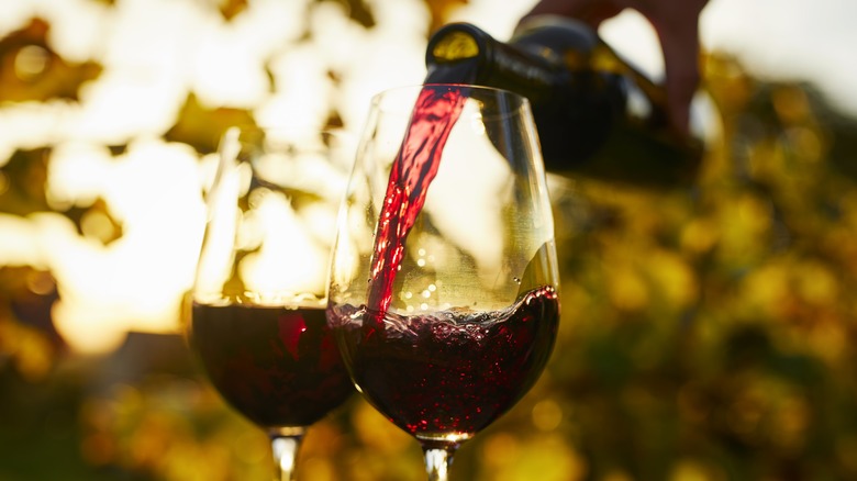 Red wine poured in glasses outdoors