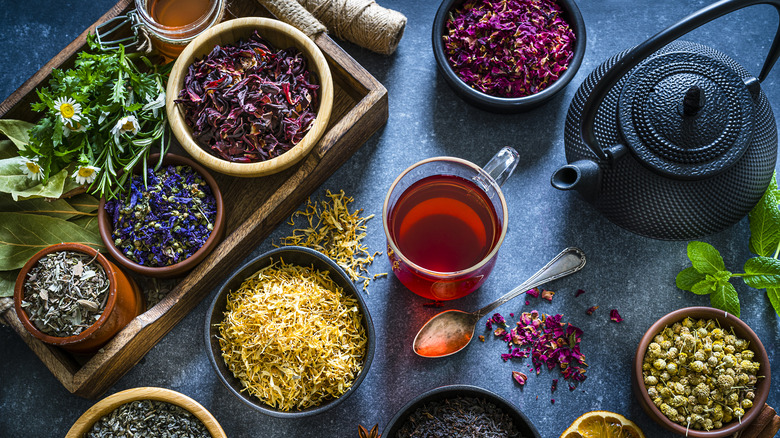 A variety of herbal teas and teapot viewed from above