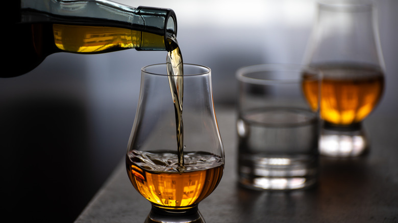 scotch being poured in a glass