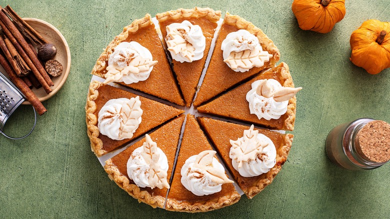 Sliced pumpkin pie on table