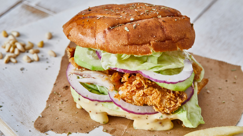 Chicken sandwich with onions and lettuce