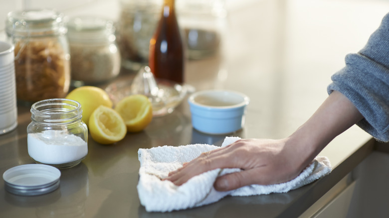 A person cleaning with baking soda and lemon