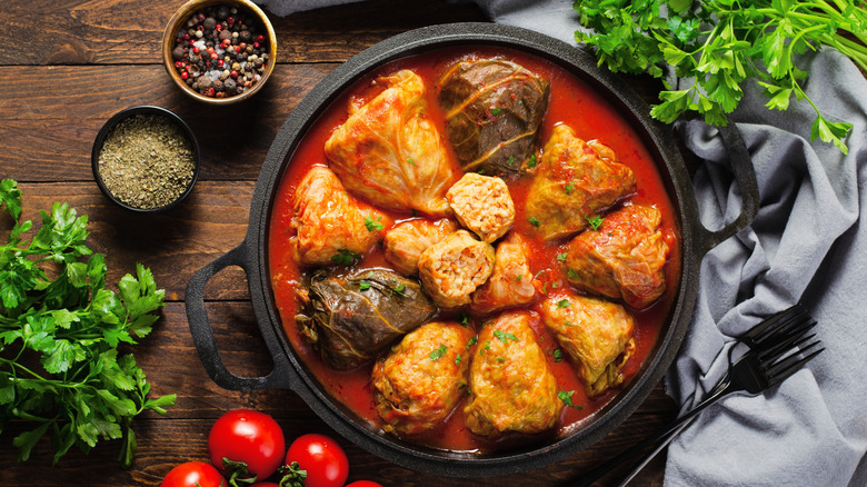 A skillet of cabbage rolls in tomato sauce