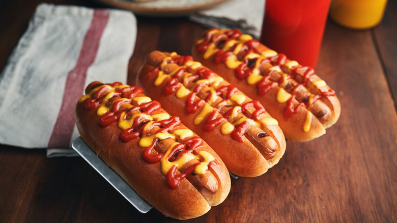 hot dogs with mustard and ketchup in buns