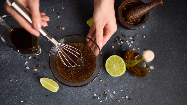 Person whisking a marinade in a bowl