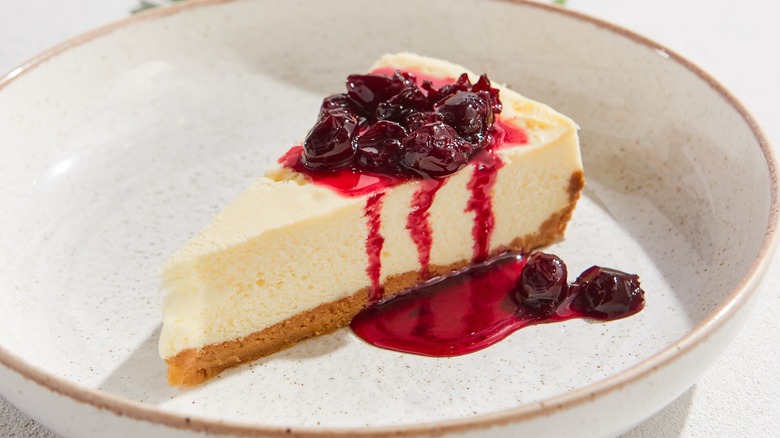 slice of cheesecake topped with drunken cherries