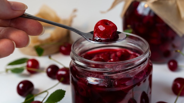 spoon with boozy cherry from jar