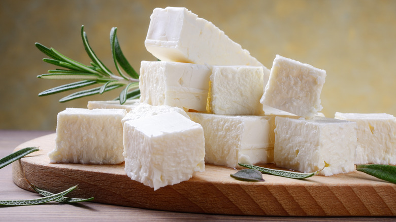 Cubes of feta sitting on cutting board