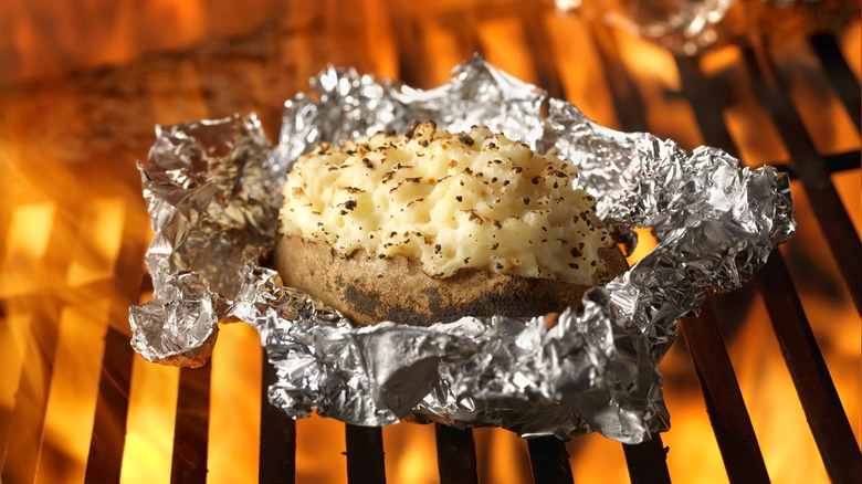 Potato on the grill in tin foil 
