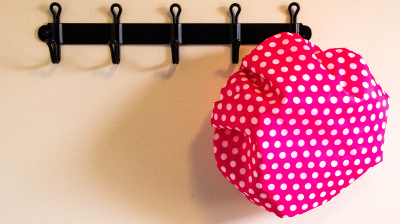 shower cap hung on rack