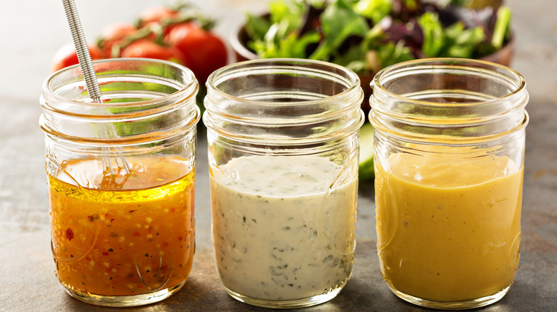 Trio of salad dressings in jars