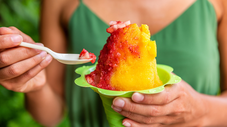 woman holding mango and strawberry shaved ice